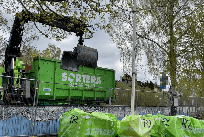 Crane picking up waste